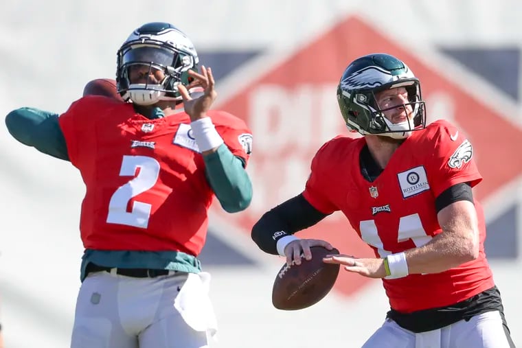 Eagles quarterbacks Carson Wentz (right) and Jalen Hurts have a friendly competition to be the team's starter.