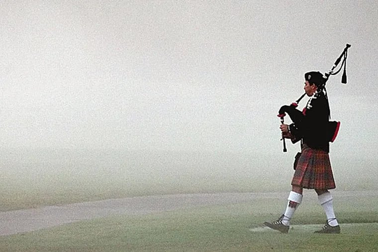Steve Agan, with the Hamilton Pipe Band, plays "Going Home" as he walks down the first fairway to start a memorial service for Payne Stewart on Oct. 28, 1999. (David J. Phillip/AP file photo)