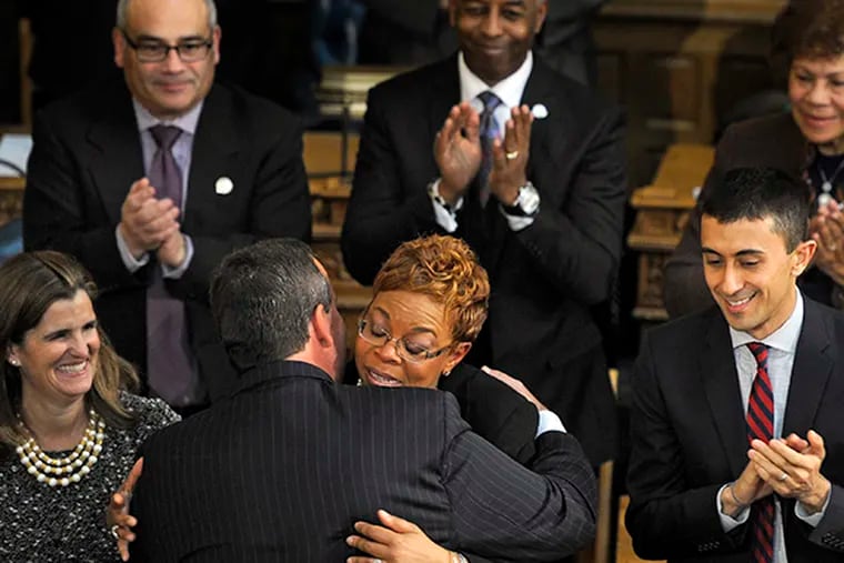 Gov. Chris Christie hugs Camden Mayor Dana Redd after giving his State of the State address in Trenton on Jan. 13, 2015. ( TOM GRALISH / Staff Photographer )