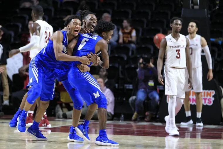 Kareem Brewton,Jr., center, of Memphis is mobbed by teammates after his 3-pointer with .7 of a second gave Memphis a 73-72 lead over Temple in overtime at the Liacouras Center on the campus of Temple University on Jan 13, 2018. Memphis went on to win 75-72.