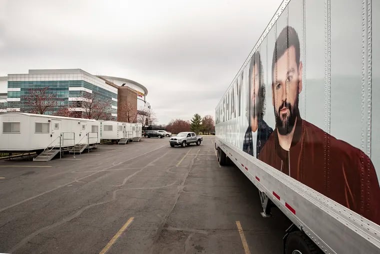 The Dan + Shay  fleet of semi-trailers that transport the bands equipment and sets sit idling in the parking lot of the Wells Fargo Center.