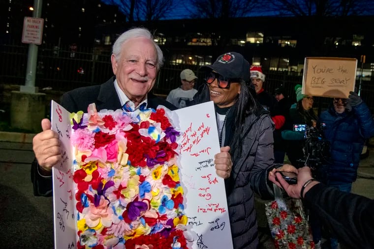 Cynthaya Johnson (right) presents Action News anchor Jim Gardner with a card signed by fans gathered for a tailgate party on Wednesday, Dec. 21 2022, in the Target parking lot. The veteran Philadelphia broadcast icon walked from the 6abc studios across the street before he anchored his final newscast at 6 p.m.