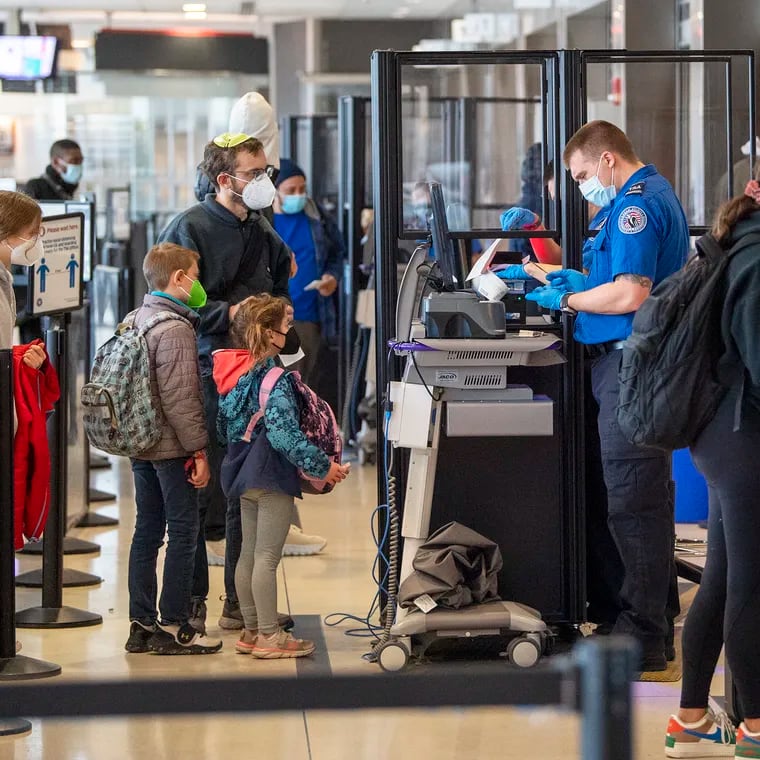 Travelers go through TSA security checkpoints on December, 21, 2021, at the Philadelphia International Airport in Philadelphia, Pa