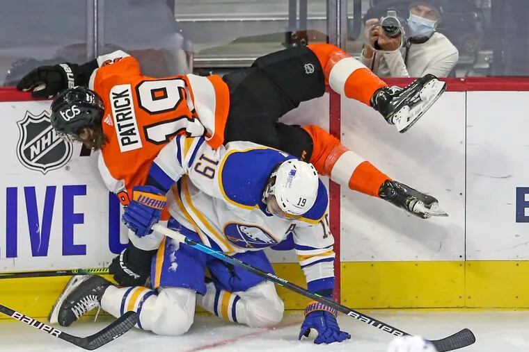 Flyers' Nolan Patrick gets up-ended by Sabres' Jake McCabe during the first period at the Wells Fargo Center in Philadelphia, Tuesday,  January 19, 2021.
