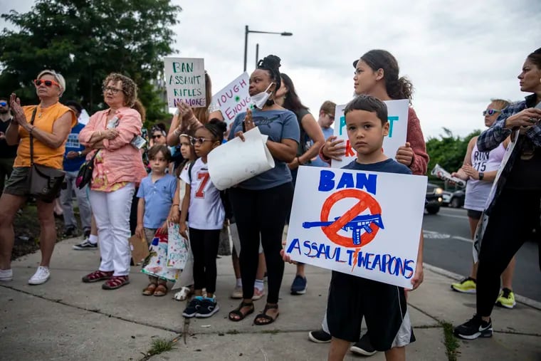Jacob King, 5, of Mount Airy, is with his father, Gary King, holds a sign reading “Ban Assault Weapons” during a gathering for the Nation wide March for Our Lives in the streets of West Philadelphia on Saturday, June 11, 2022. “Its good to get him out here and let him see what the world is about,” Gary said.