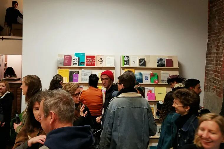 Visitors mill around the brand-new Ulises art book store at the opening-night celebration Nov. 12 in Fishtown.