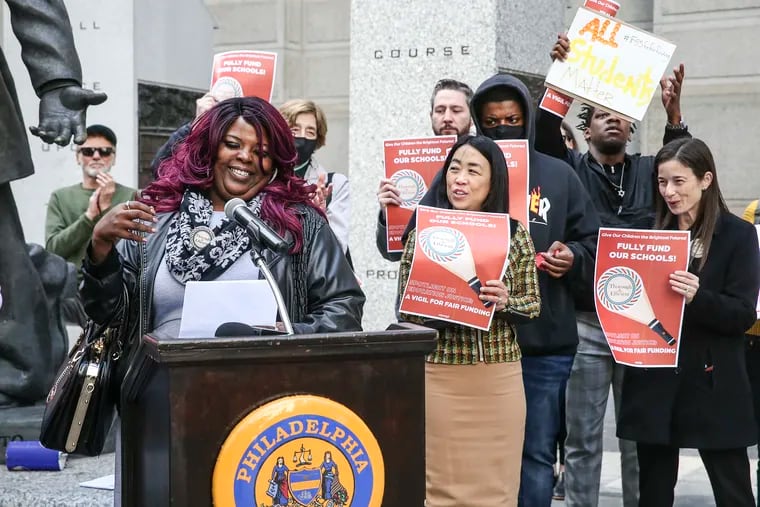In this March 2022 photo, parent Sheila Armstrong (at the microphone) and then-Councilperson Helen Gym (center) participate in a Children First School Funding Rally at the Catto Memorial Statue on the south side of City Hall.