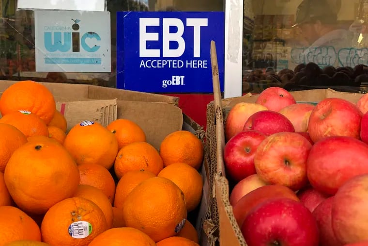 A sign noting the acceptance of electronic benefit transfer (EBT) cards that are used to issue benefits is displayed at a grocery store in Oakland, Calif. New federal legislation to raise the country’s debt limit and avoid a default came with a number of strings attached, including a change in the work requirements for people who use food stamps.