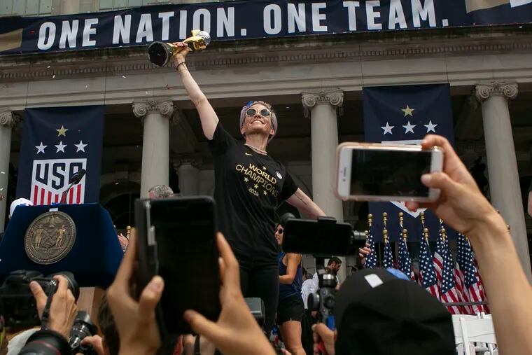 Megan Rapinoe poses for the cameras with the World Cup trophy outside of New York City Hall at a ceremony following the team's parade down the Canyon of Heroes in lower Manhattan for their World Cup win on Wednesday, July 10, 2019. The team is celebrating their consecutive World Cup win and trip to City Hall, receiving keys for the second time by New York City Mayor Bill de Blasio.