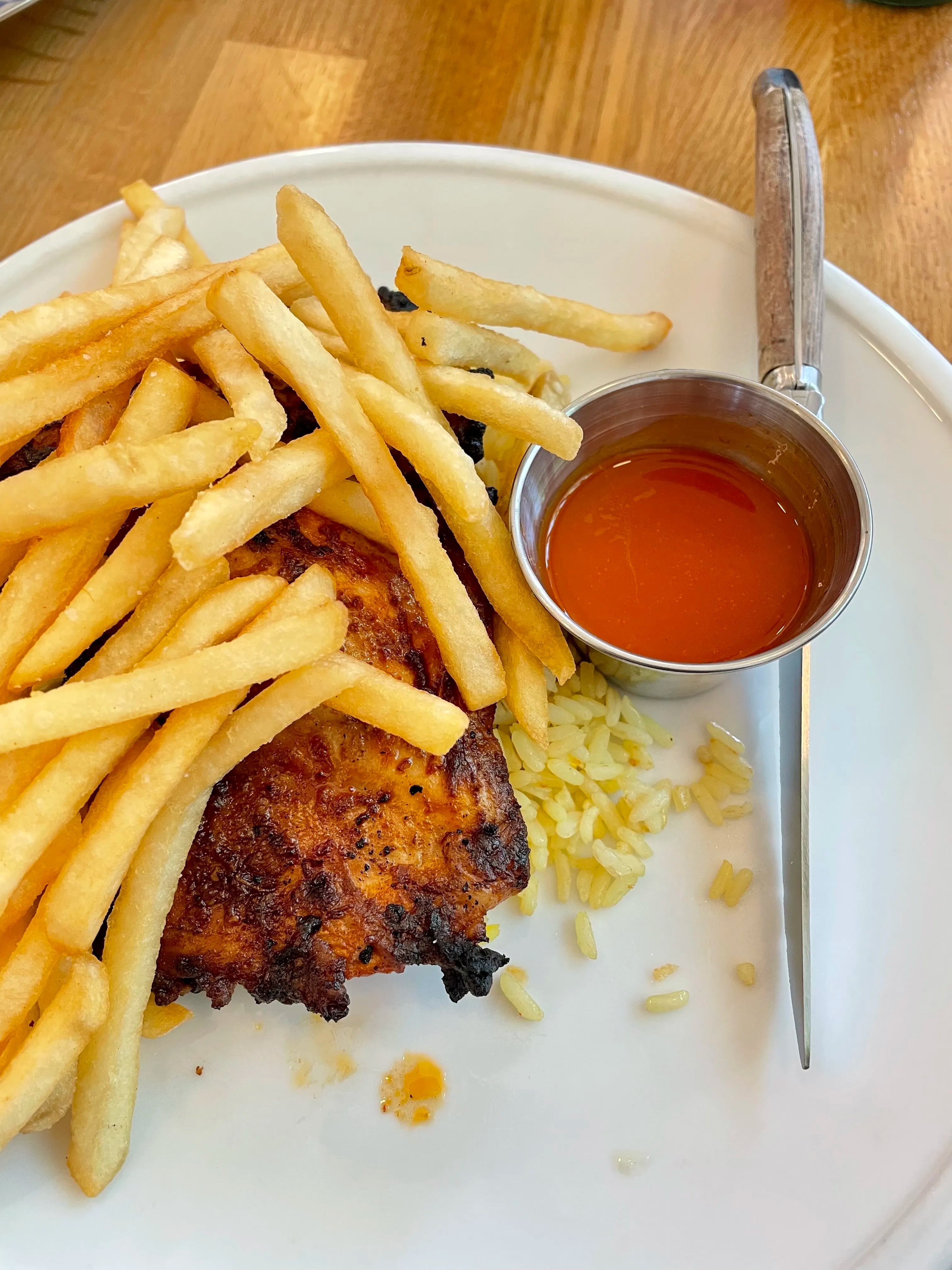 Grilled piri-piri chicken with saffron rice and French fries at Gilda Cafe & Market.