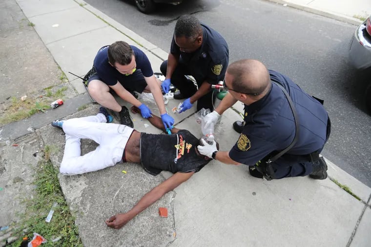 An unidentified man suspected of overdosing is administered narcan by Philadelphia Fire personnel on Witte Street in Kensington in June of 2017.