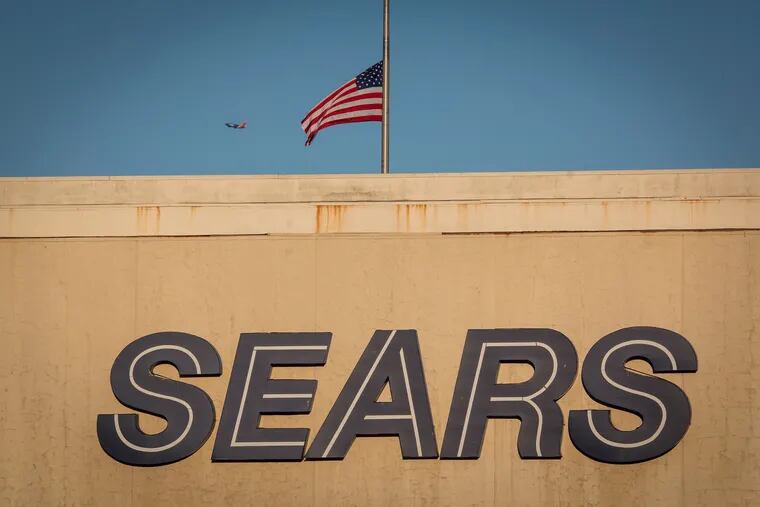 An American flag flies at half-staff above a Sears store in San Bruno, Calif., on Dec. 28, 2018. (David Paul Morris, Bloomberg)