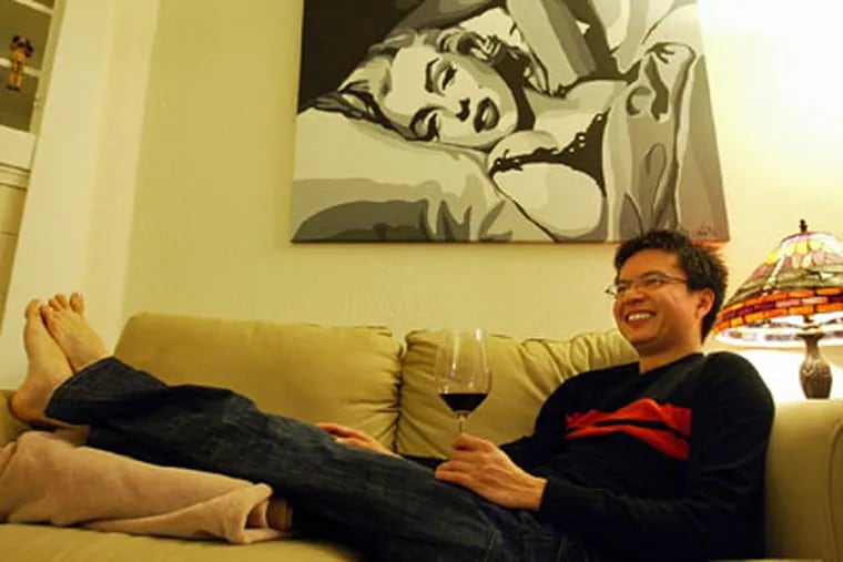Brandon Gan relaxes at home with a glass of red wine in Oakland, California. Despite his slender frame - Gan is 5-foot-6 and weighs 120 pounds - he has high cholesterol, so eating right is a must. (Aric Crabb / Contra Costa Times / MCT)