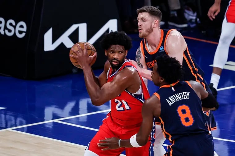 Sixers Joel Embiid double teamed by Knicks Isaiah Hartenstein and OG Anunoby during the first quarter of Game 2.