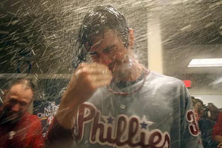 Cole Hamels got doused with Champagne after pitching a complete game in the Phillies' win. (Yong Kim/Staff Photographer)