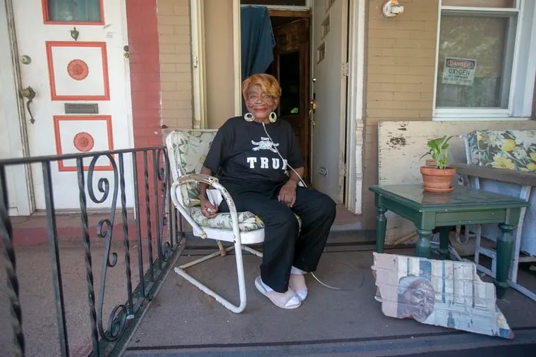 Lucille Fletcher, poses on her porch in West Philadelphi. Fletcher was featured in Doorway to Achievement, a Mural Arts Philadelphia mural, that was demolished in 2017.