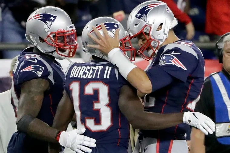 The Patriots are favored by nearly three touchdowns for Sunday's game in Miami. Tom Brady (right) is 0-5 against the spread when favored by 18 or more.