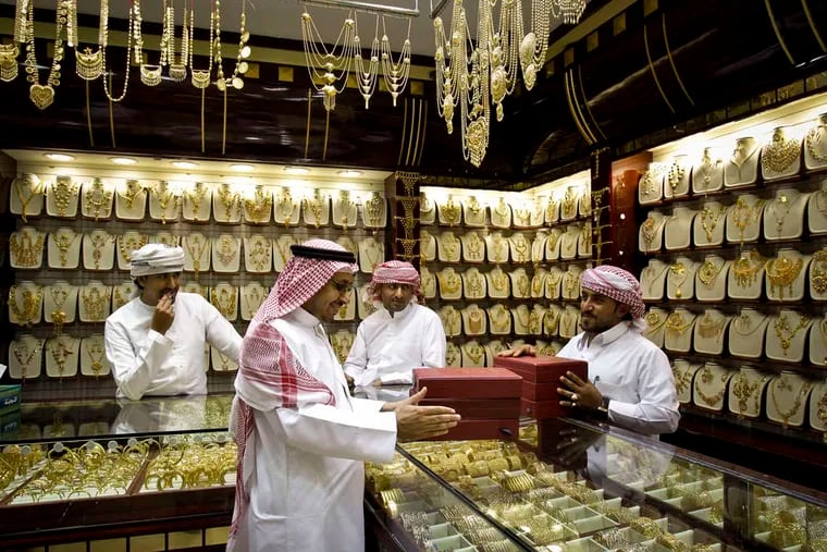 A customer from Saudi Arabia discusses his purchases. Dubai's location is key to its growth, said the head of a center that oversees the emirate's gold trade.