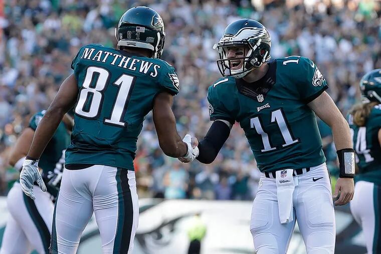Philadelphia Eagles' Carson Wentz, center, celebrates with Jordan Matthews after Matthews scored a touchdown during the first half of an NFL football game against the Pittsburgh Steelers, Sunday, Sept. 25, 2016, in Philadelphia.