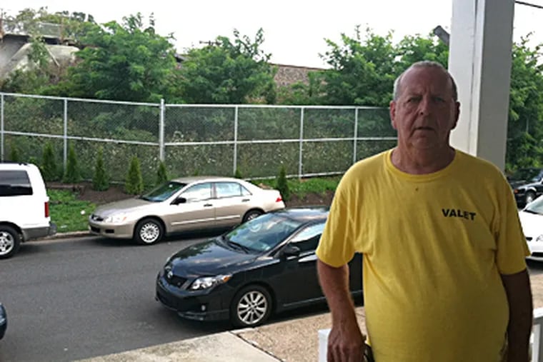 Joe Coffman's porch on Garden Street faces the chain-link fence Amtrak erected. BILL REED / Staff