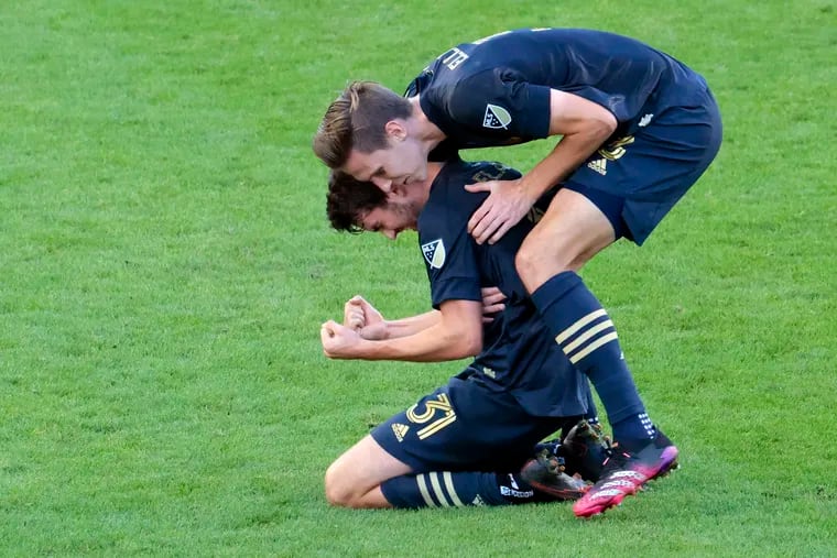 Jack Elliott (right) celebrates with Leon Flach after Flach's goal capped the Union's 3-0 win over the Columbus Crew on Sunday at Subaru Park.
