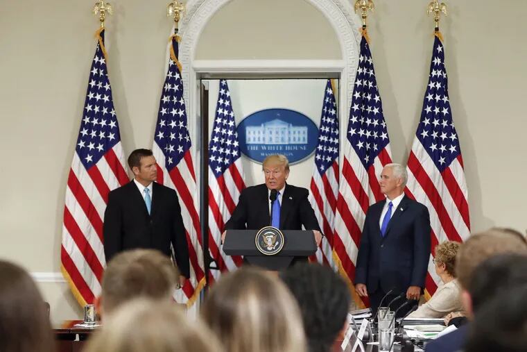 President Trump, with Kansas Secretary of State Kris Kobach (left) and Vice President Pence, at a meeting Wednesday of the Presidential Advisory Commission on Election Integrity.