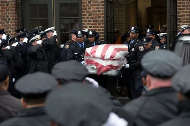 Members of the Philadelphia Police Department carry the casket of fallen Philadelphia Police Officer Robert Wilson III on March 14, 2015.
