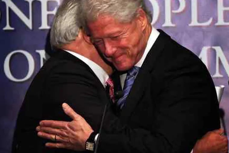 Former President Bill Clinton hugs Leonard Barrack, president of the Jewish Federation of Greater Philadelphia.