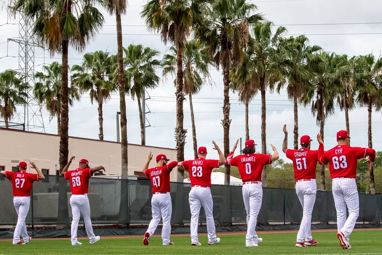 Phillies pitchers warmup during spring training workouts at BayCare Ballpark  in Clearwater, Fla., on Wednesday.