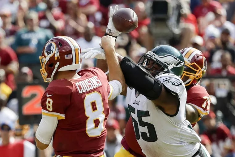 Eagles defensive end Brandon Graham forces a fumble on Redskins quarterback Kirk Cousins after getting past offensive tackle Morgan Moses in the fourth quarter of the Eagles 30-17 win on Sunday.