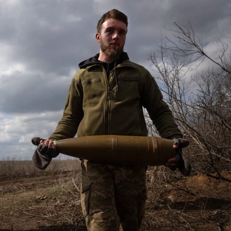 Ukrainian soldiers carry shells to fire at Russian positions on the front line, near the city of Bakhmut, in Ukraine's Donetsk region, on March 25. Approval by Congress of a $61 billion package for Ukraine means an infusion of new firepower. But the clock is ticking. Russia is using all its might to achieve its most significant gains since the invasion by a May 9 deadline.