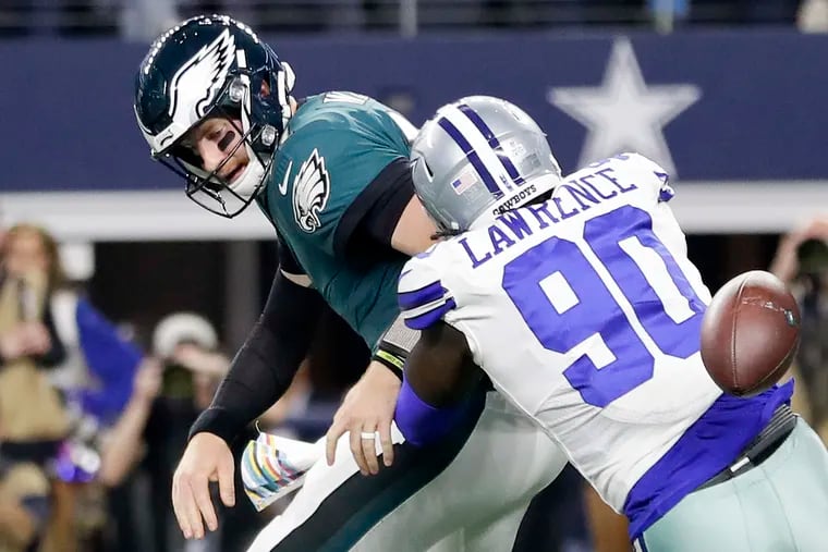 Eagles quarterback Carson Wentz fumbling as he is pressured by Cowboys defensive end DeMarcus Lawrence in an October loss.