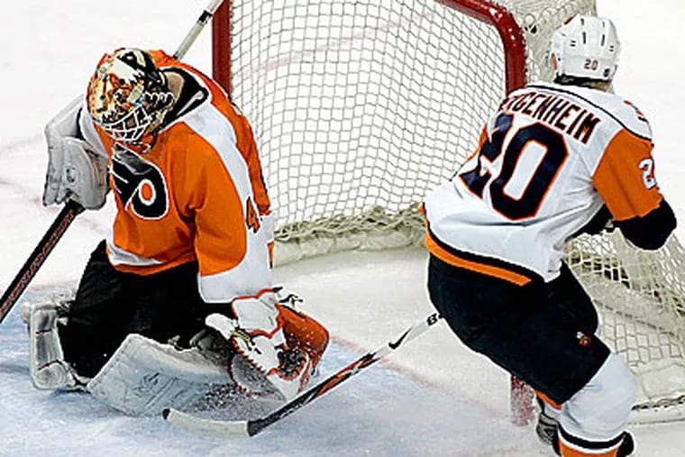 Flyers goalie Martin Biron makes a glove save on the shot by Islanders left wing Sean Bergenheim on a break away during the second period. The Flyers won 5-1. (AP Photo/Tom Mihalek)