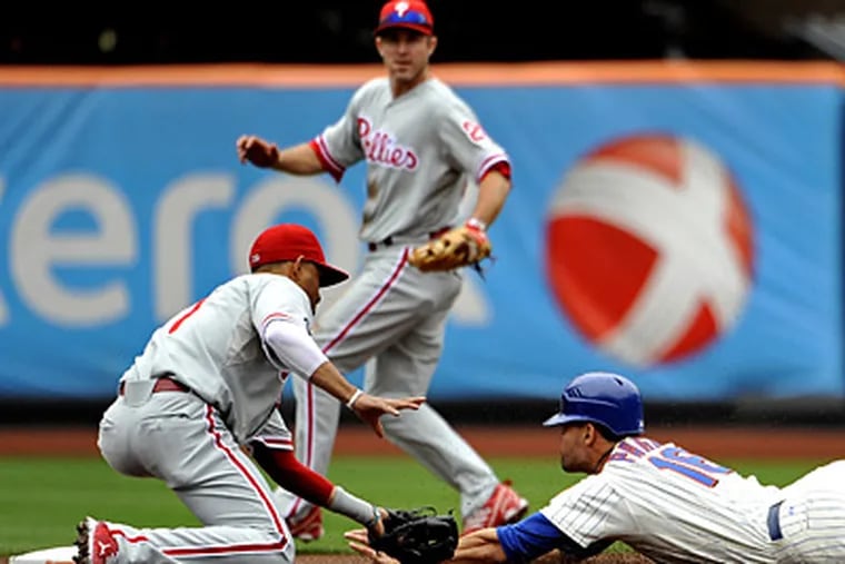 Mets' Angel Pagan is tagged out by Wilson Valdez while trying to steal second in the Phillies' 3-0 win. (AP Photo/Kathy Kmonicek)