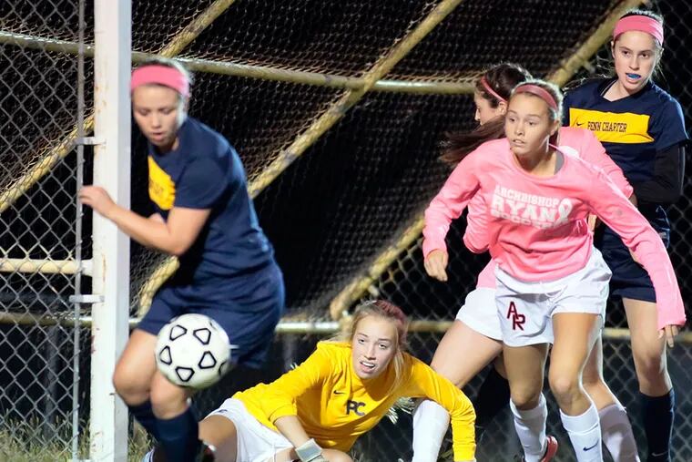 Penn Charter #5 Brigitte Gutpelet (far left), goalie Mackenzie Listman and # 25 Hannah Fox (far right) look to clear the ball as Archbishop Ryan # 7 Haley O'Neill presses on in the 1st half of the Penn Charter at Archbishop Ryan H.S. girls soccer game on October 7, 2015.