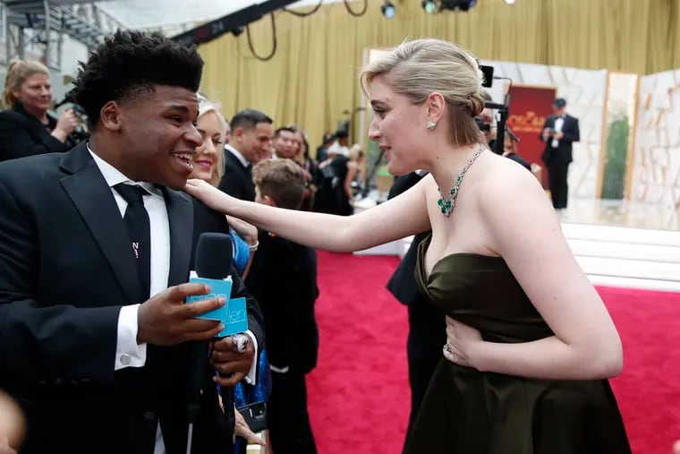 Greta Gerwig, right, talks to Jerry Harris on the red carpet at the Oscars in Los Angeles on Feb. 9, 2020.