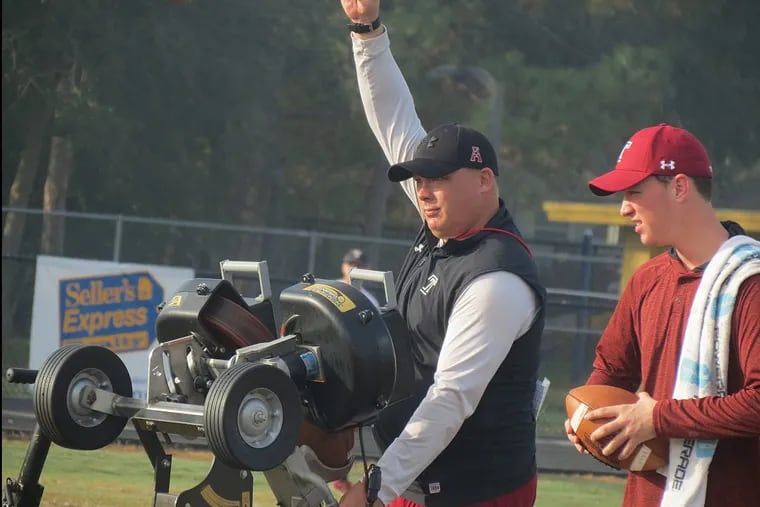 Temple Owls football head coach Geoff Collins feeding the jugs machine for a punt returning drill during Tuesday’s practice ahead of the Gasparilla Bowl.