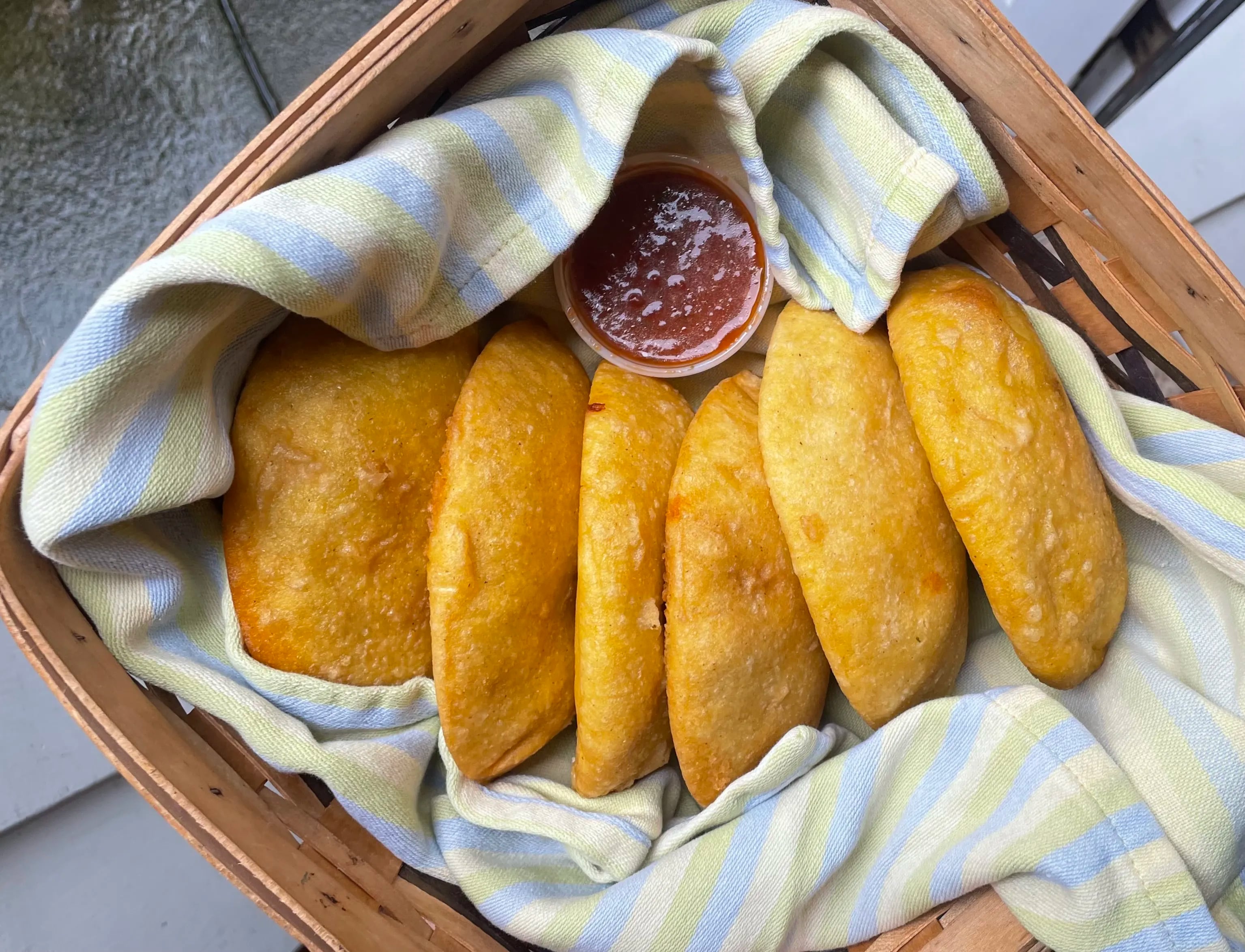 An assortment of hot empanadas from Sazon 2 Go, a Venezuelan stand at local farm markets that represents a tasty comeback for the owners of a longstanding restaurant that closed during the pandemic.