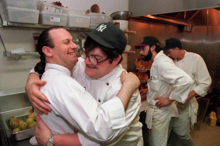 Chefs Douglas Rodriguez (right) and Guillermo Pernot hugging in 1995 at an event in Philadelphia, three years before Pernot opened ¡Pasion! and six years before Rodriguez opened Alma de Cuba.