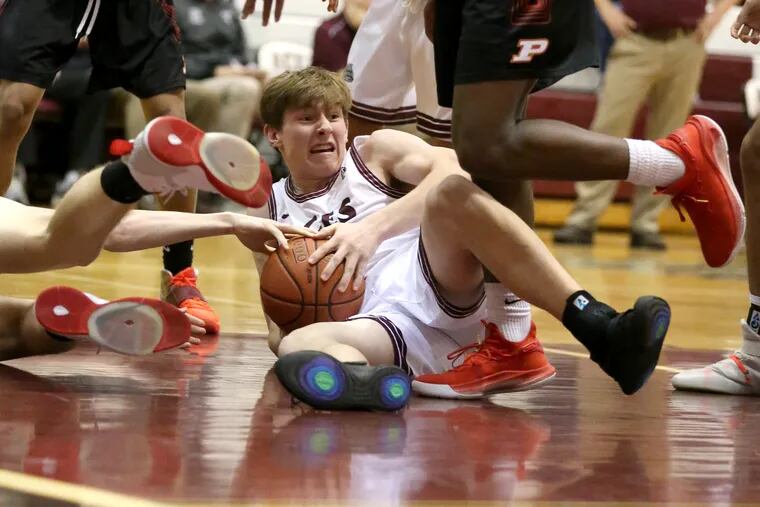 Henry Bard of Lower Merion comes up with a loose ball after a 4th quarter scramble against Penncrest in a key Central League boys' basketball game.on Jan. 14, 2020.