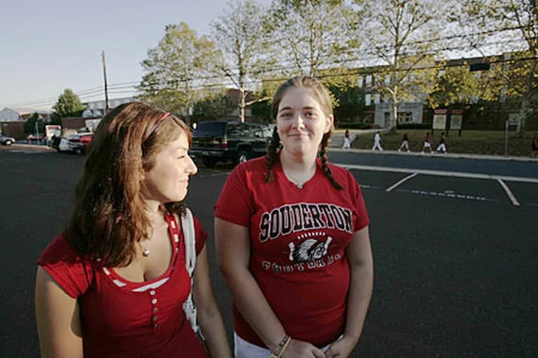 Deniors Bianca Cavacini, 17 (left), and Liz Kramlik, 17, showed up for school as striking teachers picket in front of Souderton Area High School.