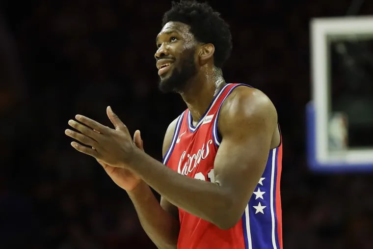 Sixers center Joel Embiid claps his hands during a break in the first-quarter against the Detroit Pistons on Friday.