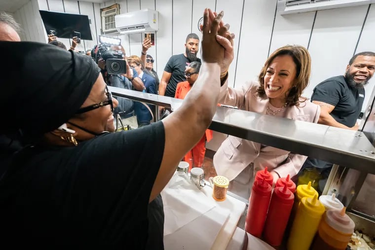 Genevia Ware (left), from Jim’s West Steaks and Hoagies, and Vice President Kamala Harris (right), high five at the shop in West Philadelphia. The Vice President went to Jim’s West after giving the keynote speech at the SEIU convention.