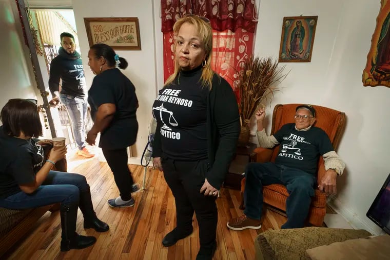 Evelyn Reynoso (center) prepares to leave for Harrisburg for the commutation hearing for her husband, Pedro Reynoso, who has been incarcerated 25 years. Pedro's son, Juan Alexander Reynoso Roman, is in the doorway, and Pedro Reynoso Sr., who flew up from the Dominican Republic to support his son's release, sits in a chair.