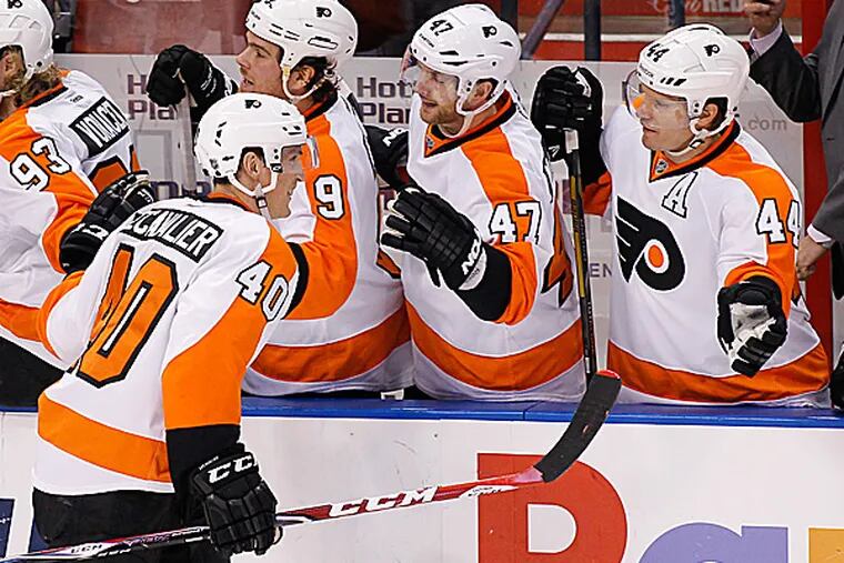 Flyers center Vincent Lecavalier celebrates with teammates after scoring a goal during the second period. (Terry Renna/AP)