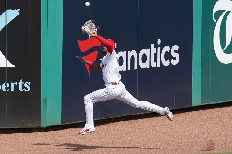 Phillies center fielder Johan Rojas makes a leaping catch at the wall in a Feb. 28 exhibition game against the Braves at BayCare Ballpark in Clearwater, Fla.