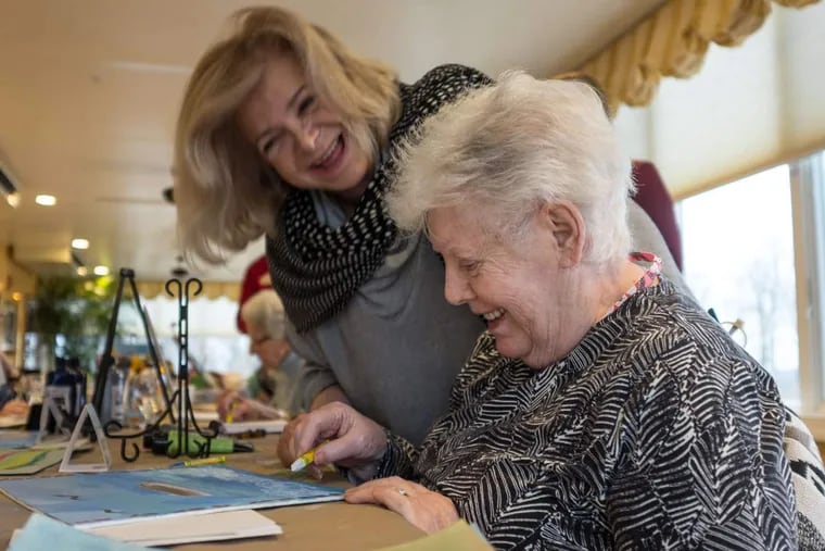 Art therapist Dona Duncan (left) works with Brandywine Assisted Living Facility resident Dorothy Manion as part of the facility's new partnership with the Pennsylvania Academy of the Fine Arts.