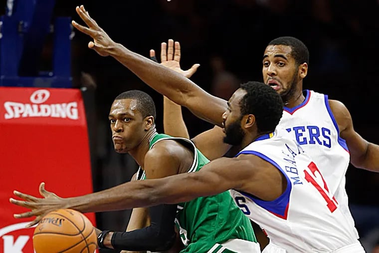 The 76ers' Brandon Davies and Luc Mbah a Moute defend the Celtics' Rajon Rondo. (Yong Kim/Staff Photographer)