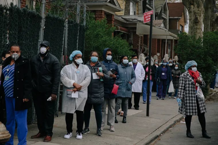 Medical workers line up for free personal protective equipment outside University Hospital of Brooklyn.