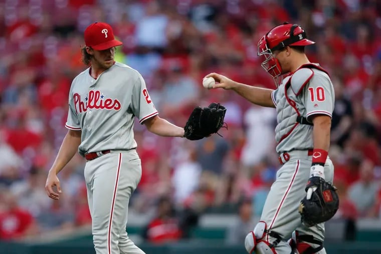 Aaron Nola (left) spotted the Cincinnati Reds a 5-0 lead by allowing five runs in the first two innings. Nola lasted just four innings in what was his briefest start since April 15 at home against the New York Mets.